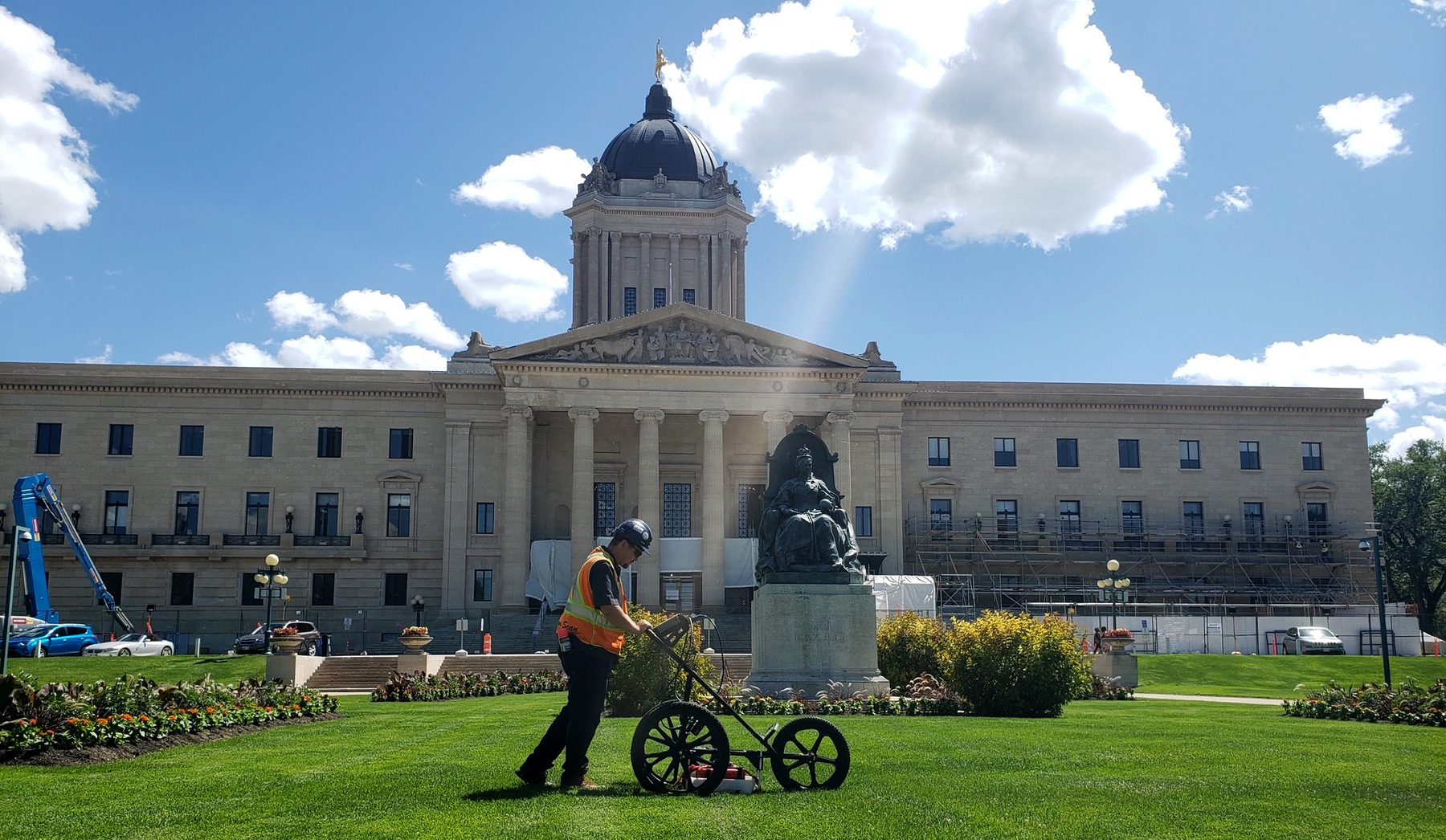 Structure Scan technician pushing a GPR cart across the Manitoba Legislative Building grounds