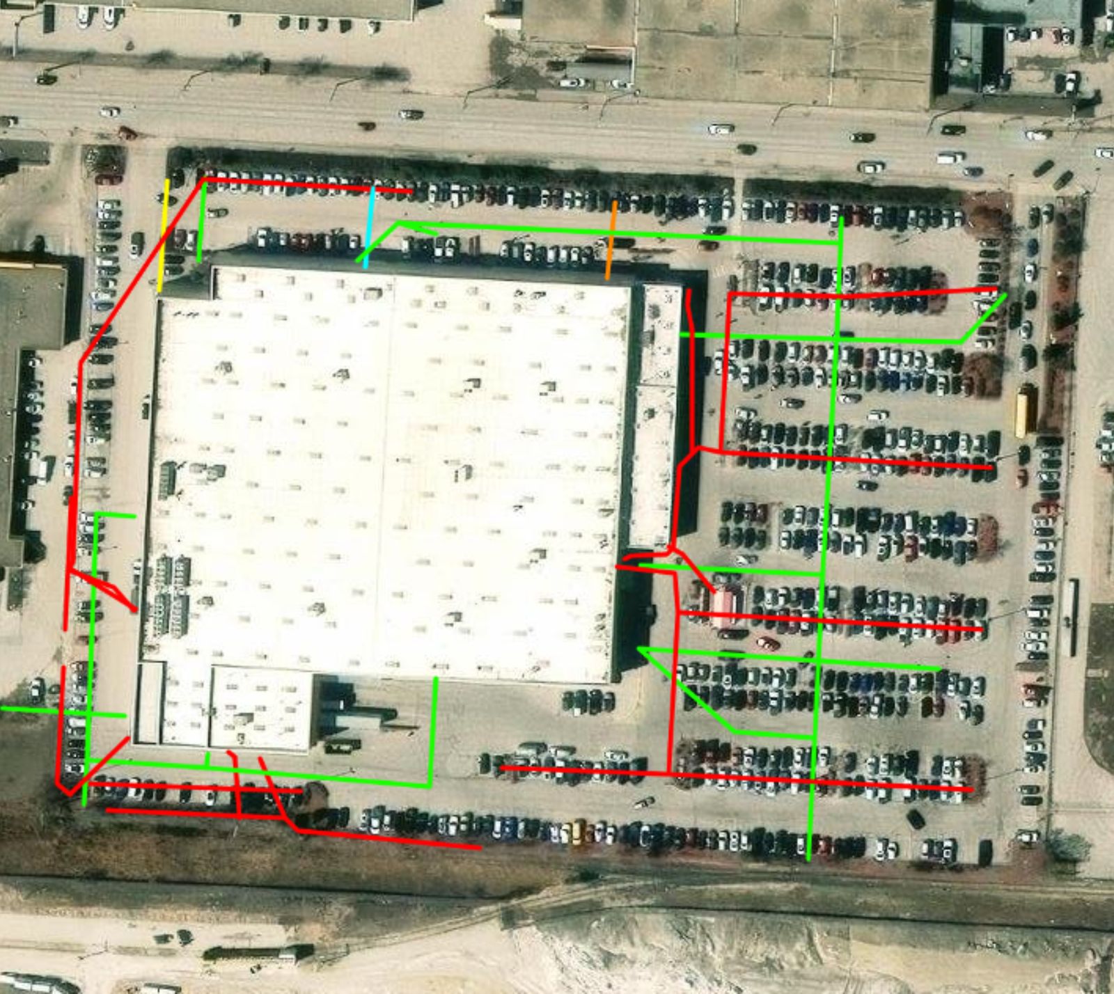 Aerial utility map with colour-coded service paths around a commercial building